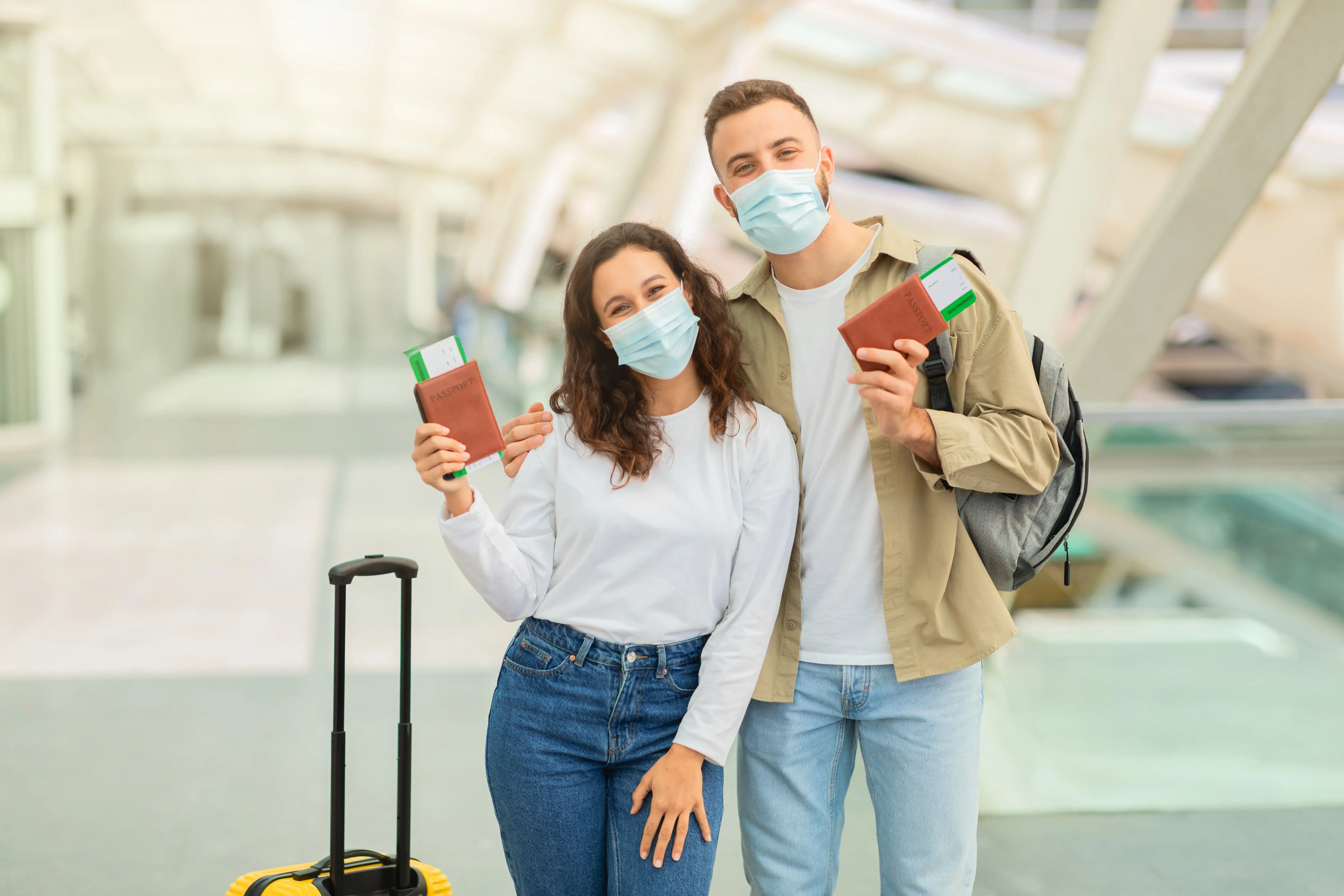 couple at airport holding passports and tickets for Schengen visa travel from Dubai